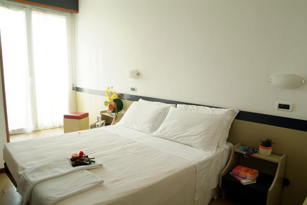 Postel nebo postele na pokoji v ubytování Hotel Universal
