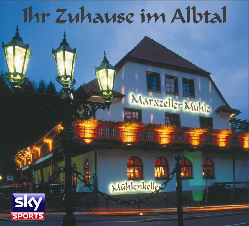 a building with a street light in front of it at Hotel Marxzeller Mühle in Marxzell