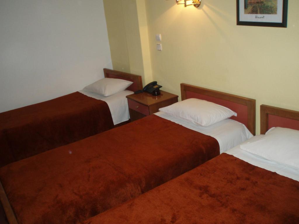 A bed or beds in a room at Hotel Orfeas