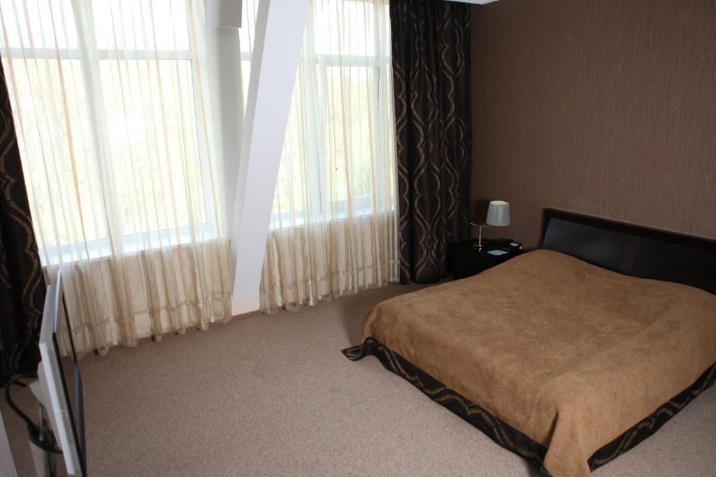 Postel nebo postele na pokoji v ubytování Lavina Hotel