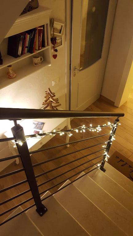 a bed with lights on it in a room at Casa Mafalda in Chioggia