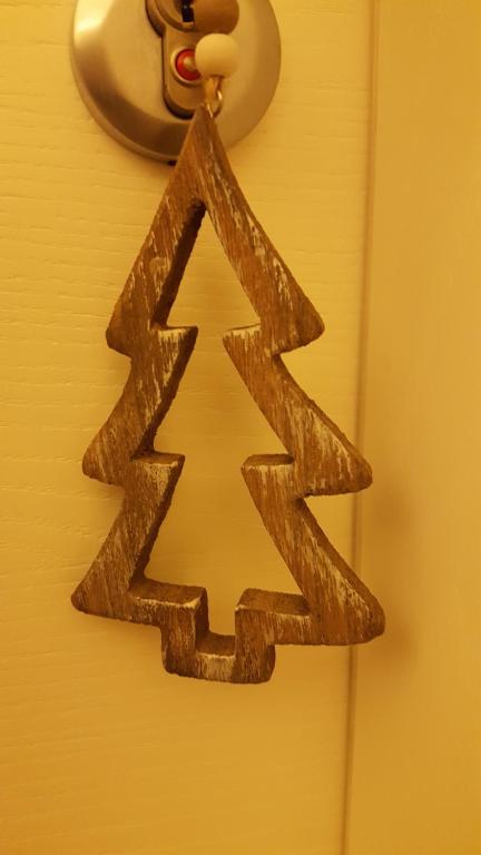 a wooden arrow sign hanging on a door at Casa Mafalda in Chioggia