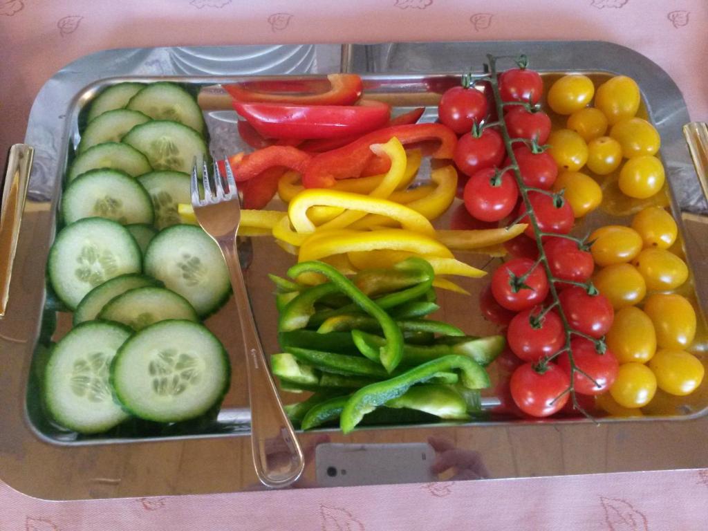 a tray filled with fruits and vegetables with a fork at Retzerlandhof Familie Graf in Zellerndorf