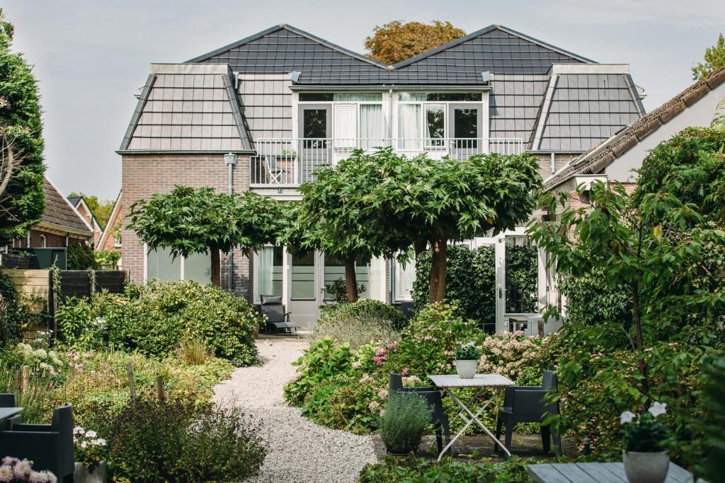 a house with a garden in front of it at Kranenbergh Boutique Apartments in Bergen