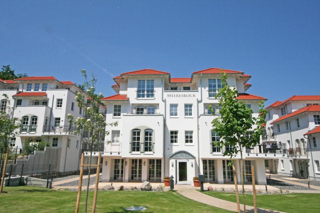 a large white building with red roof at Haus Meeresblick A 2 23 Silberdistel mit Balkon in Baabe