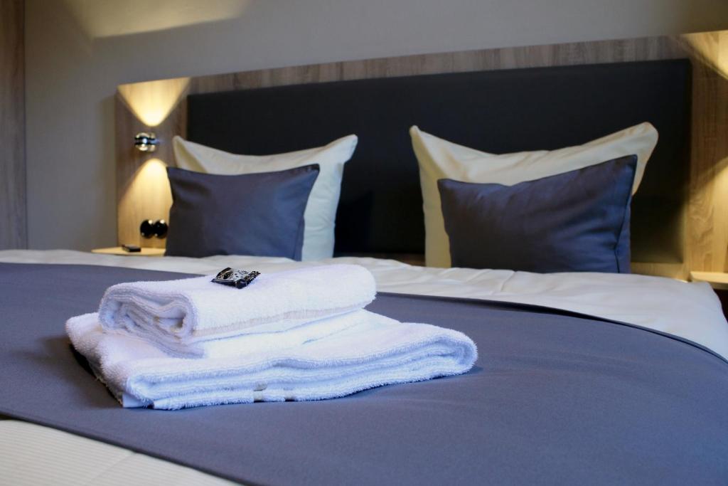 Postel nebo postele na pokoji v ubytování Hotel garni Tilia