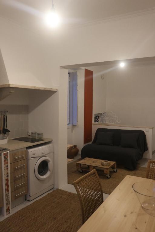 a living room with a couch and a table at Nooks Sintra three in Sintra