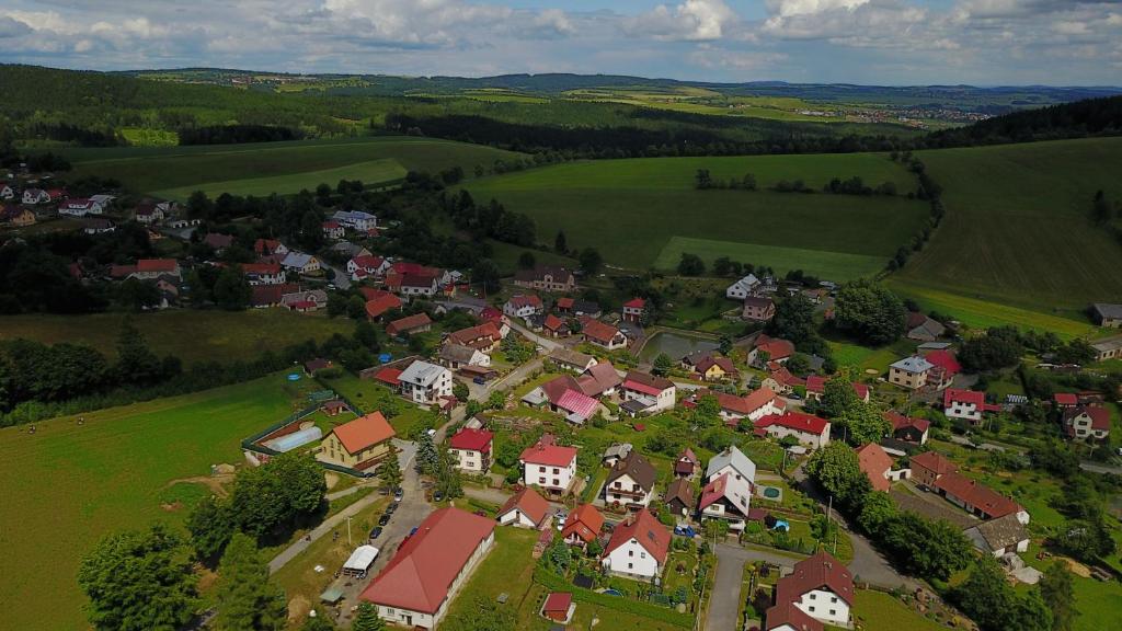 un piccolo villaggio in un campo verde con case di Ubytování U Kapličky a Nové Město na Moravě