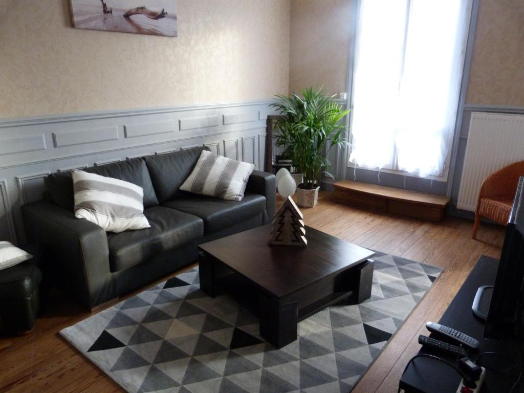a living room with a couch and a coffee table at la villa mersoise in Mers-les-Bains