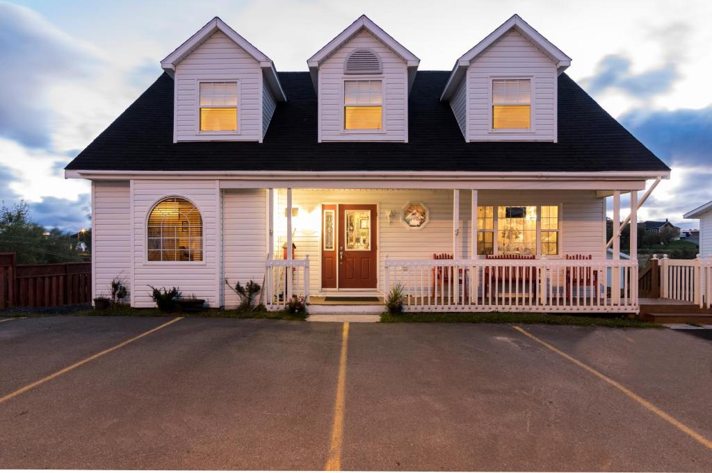 a white house with a black roof at Whitsha Inn B&B in Twillingate