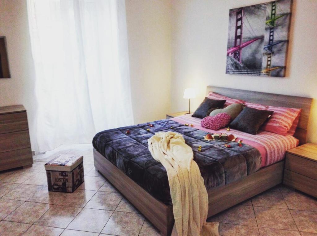 a bedroom with a bed with a blanket on it at Alpivida Home in Naples