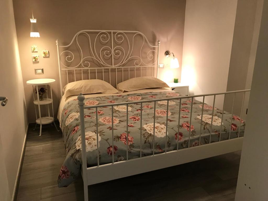 a bedroom with a bed with a metal bed frame at Sweet Holiday Home in Bernalda