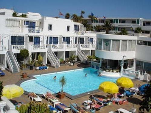 a large swimming pool in front of a hotel at San Francisco Park in Puerto del Carmen