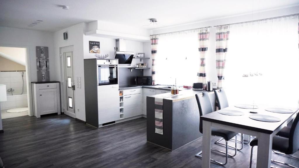 a kitchen and dining room with a table and chairs at FW-Siegel in Singen