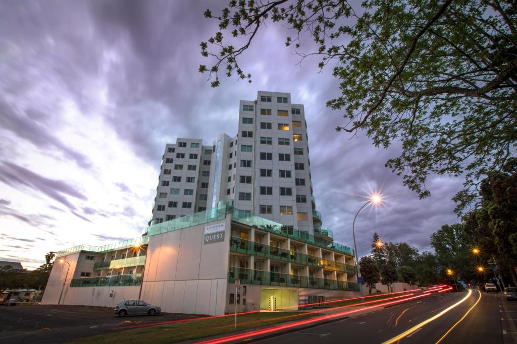 a tall building on a city street at night at Quest on Durham in Tauranga