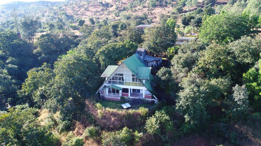 an aerial view of a house in the forest at Wind Chalet in Koynanagar