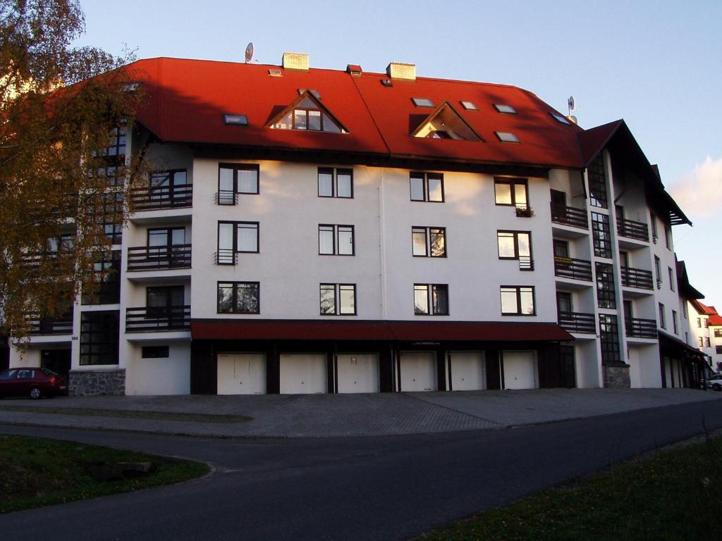 a large white building with a red roof at Apartmán Chlupáč in Harrachov