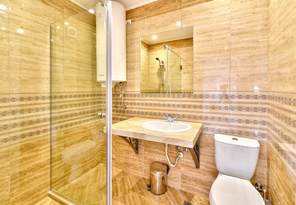a bathroom with a toilet and a sink at Sirena Palace Family Hotel in Obzor