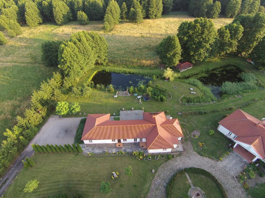 an aerial view of a large house with a pond at POD ORŁEM in Wałcz