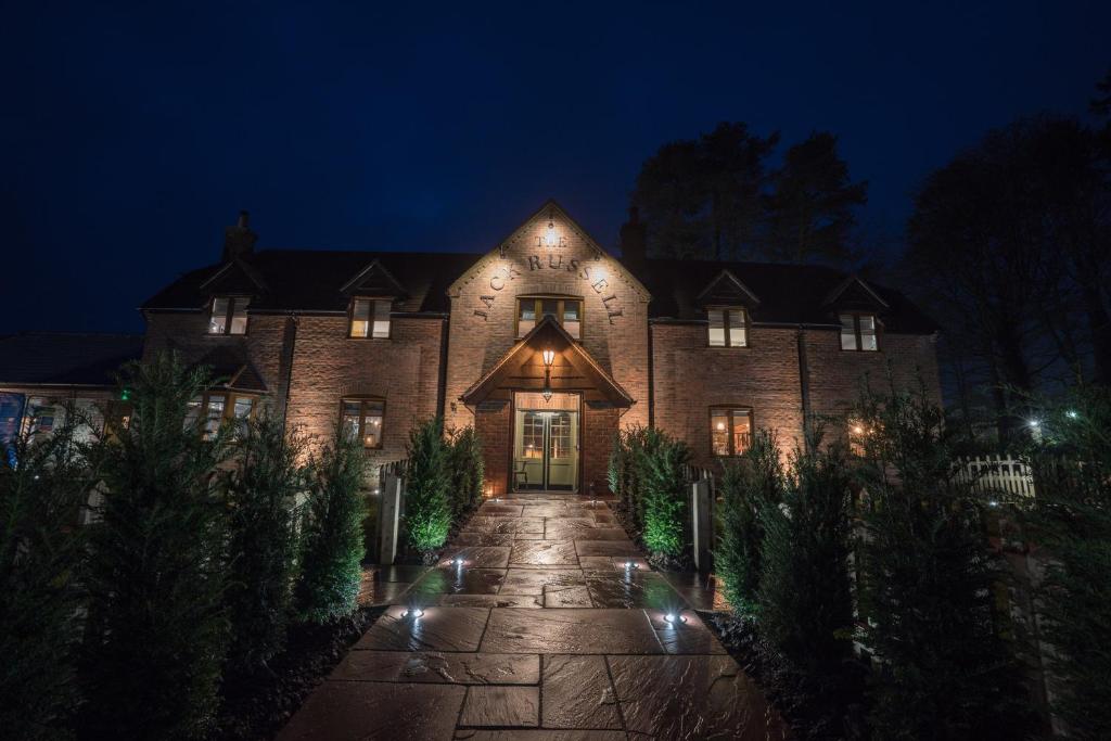 a large brick house at night with lights at The Jack Russell in Andover