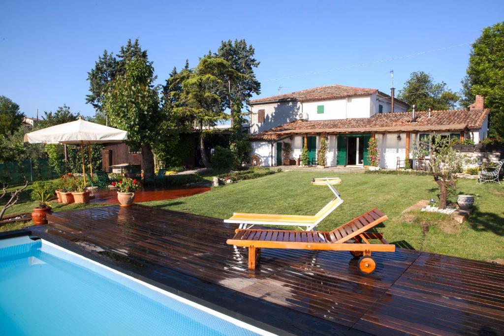 a house with a swimming pool and a house at Casa S.Paolo in Rimini