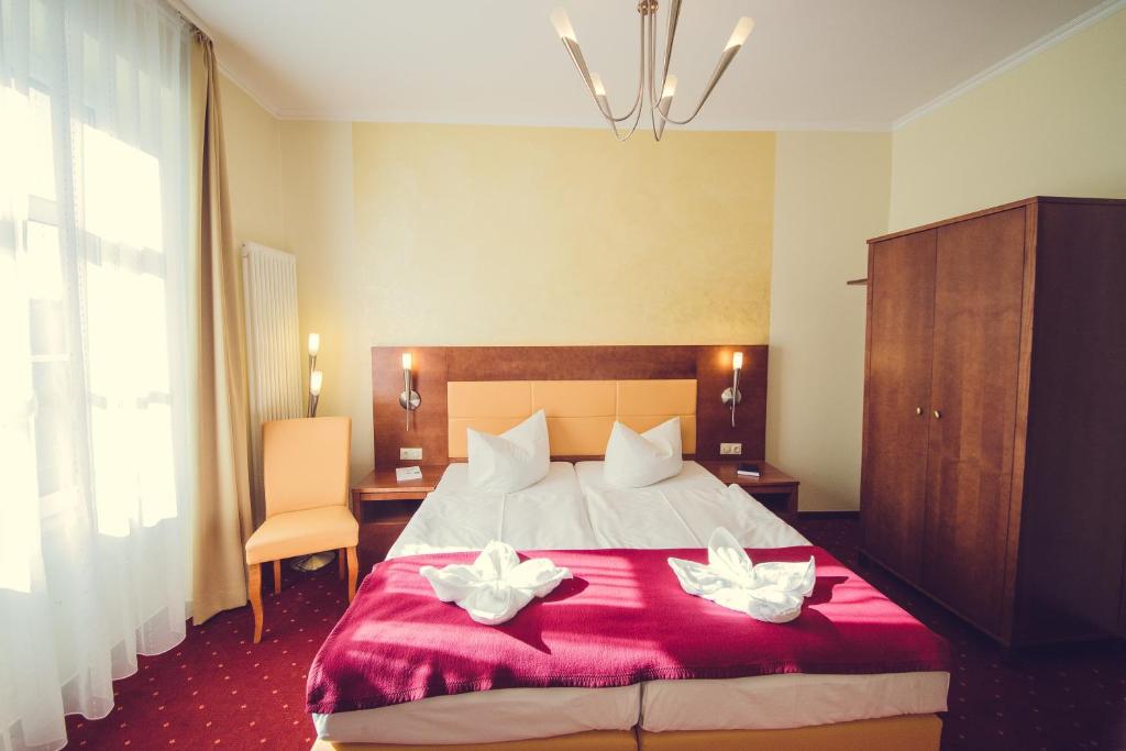 Postel nebo postele na pokoji v ubytování Hotel Arena City