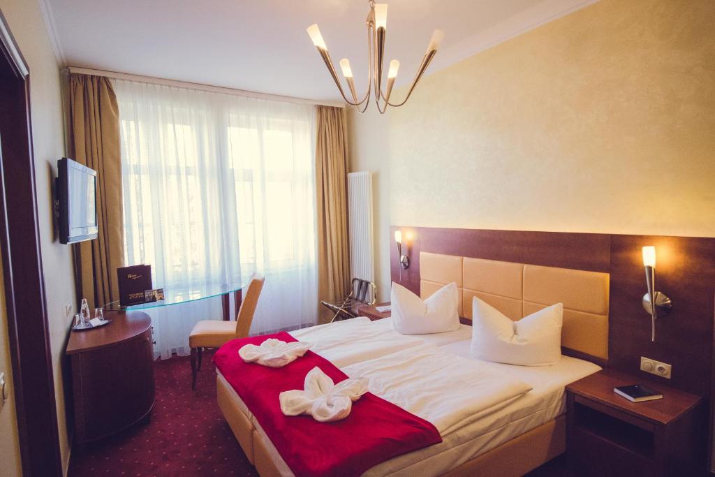 Postel nebo postele na pokoji v ubytování Hotel Arena City