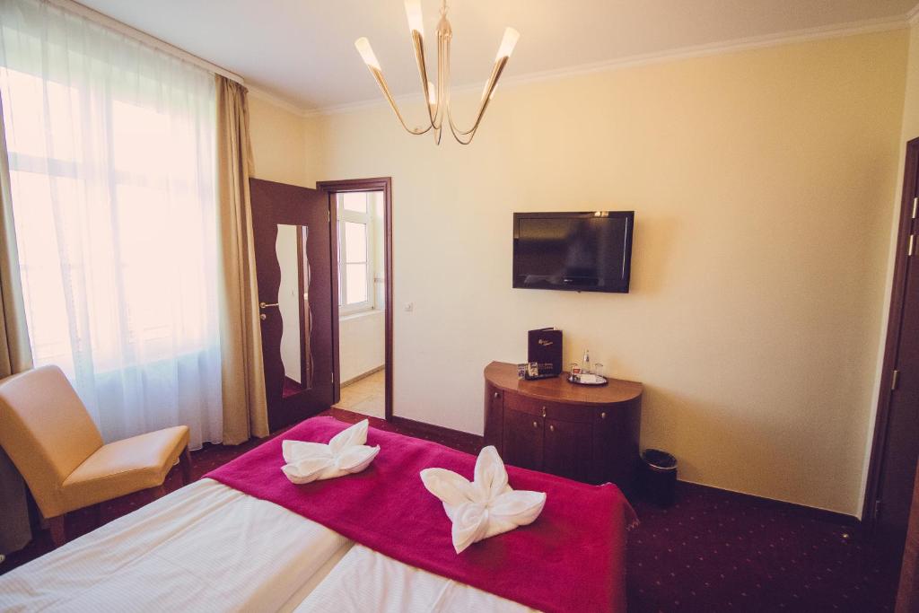Postel nebo postele na pokoji v ubytování Hotel Arena City