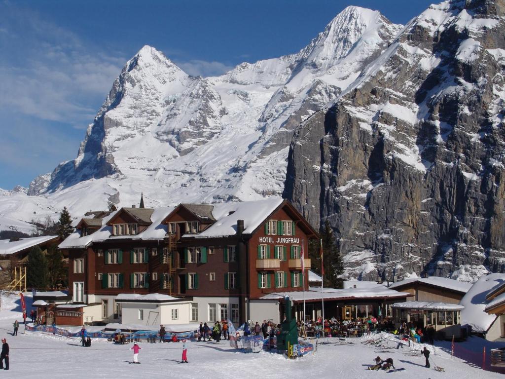 um alojamento de esqui em frente a uma montanha coberta de neve em Hotel Jungfrau Mürren em Mürren