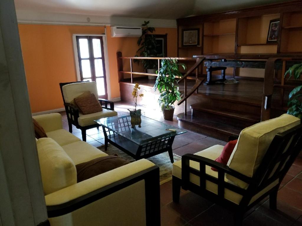 a living room with two couches and a coffee table at The Landmark St Thomas 3BR Apt in Fort Christian