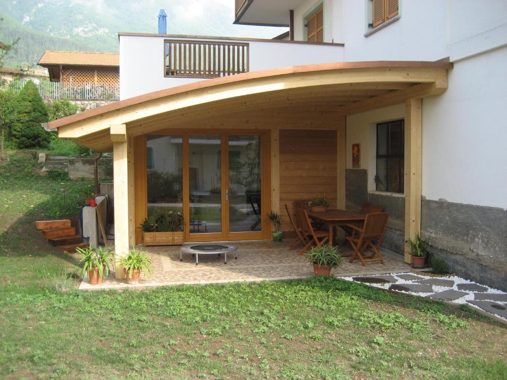 a patio with awning on the side of a house at Il Granello in Tuenno