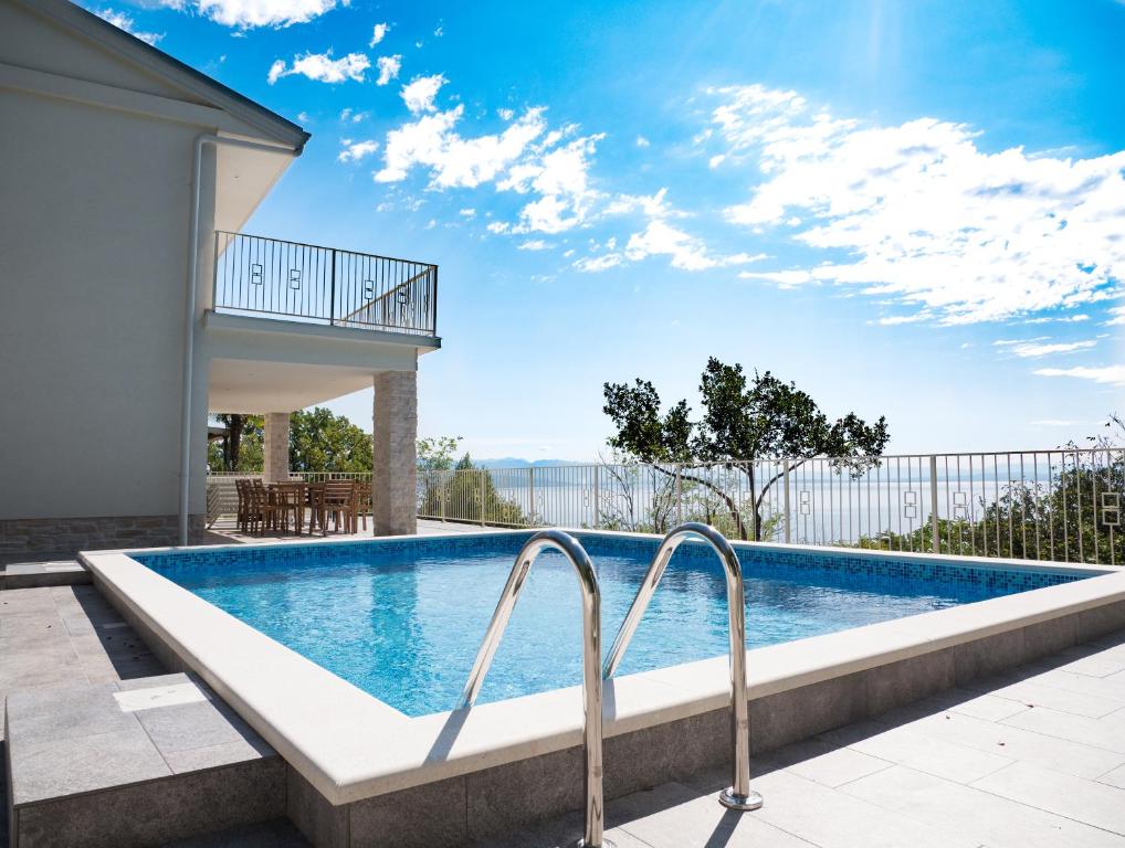 a swimming pool in the backyard of a house at Villa Carmen in Opatija