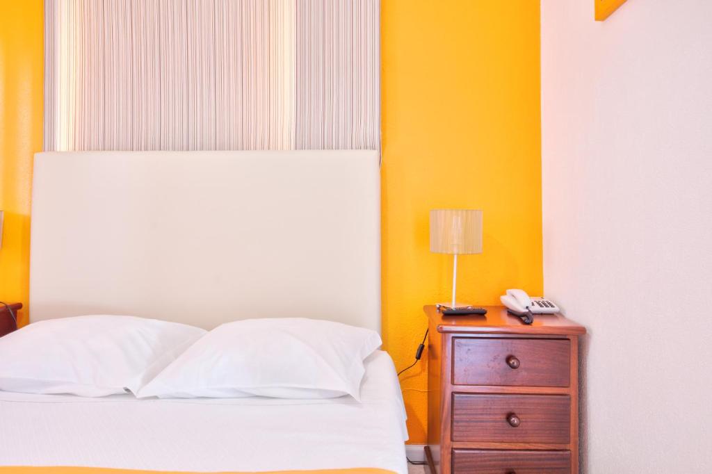 Postel nebo postele na pokoji v ubytování Hotel Palmeira