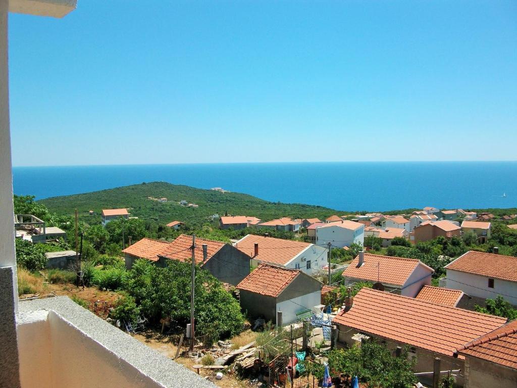 a view of a small town with houses and the ocean at Apartments Petrovic in Krimovice