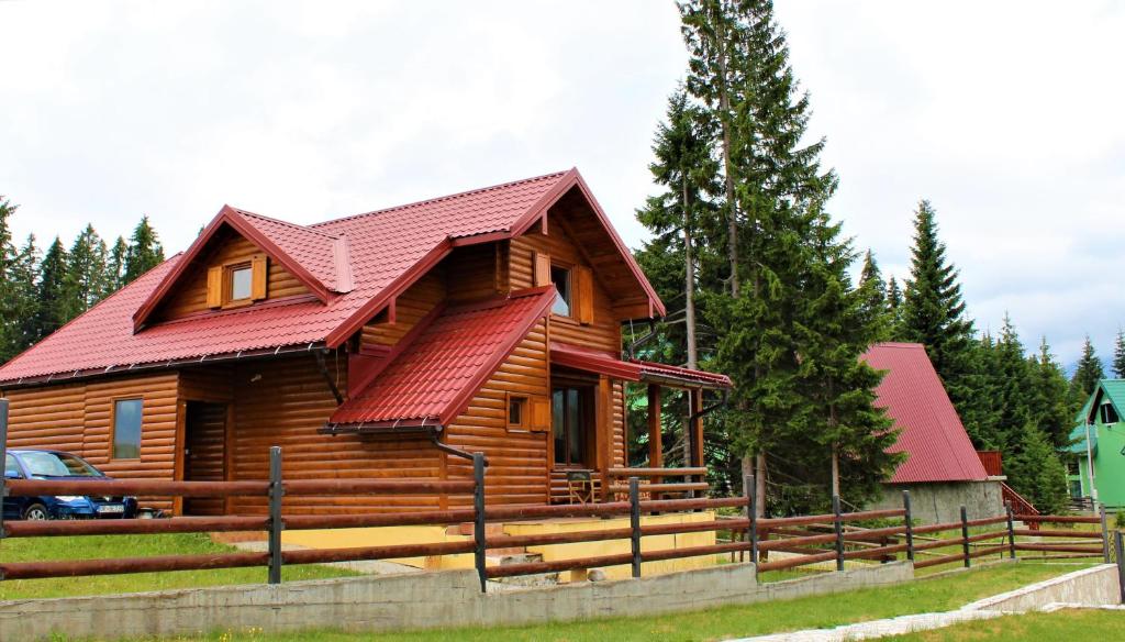 a log cabin with a red roof at Mountain Family House Zara in Žabljak