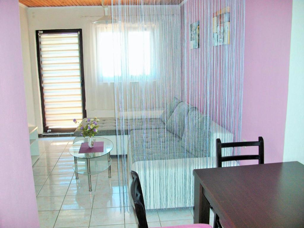 a living room with a couch and a table at Apartments Petrovic in Krimovice