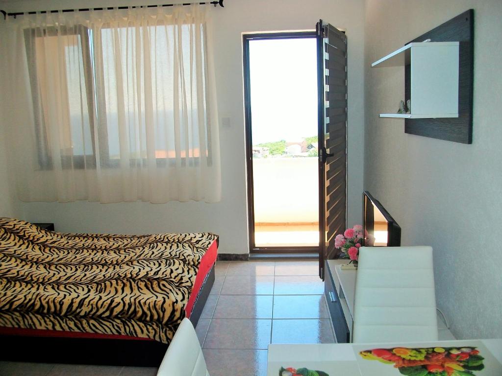 a living room with a couch and a large window at Apartments Petrovic in Krimovice