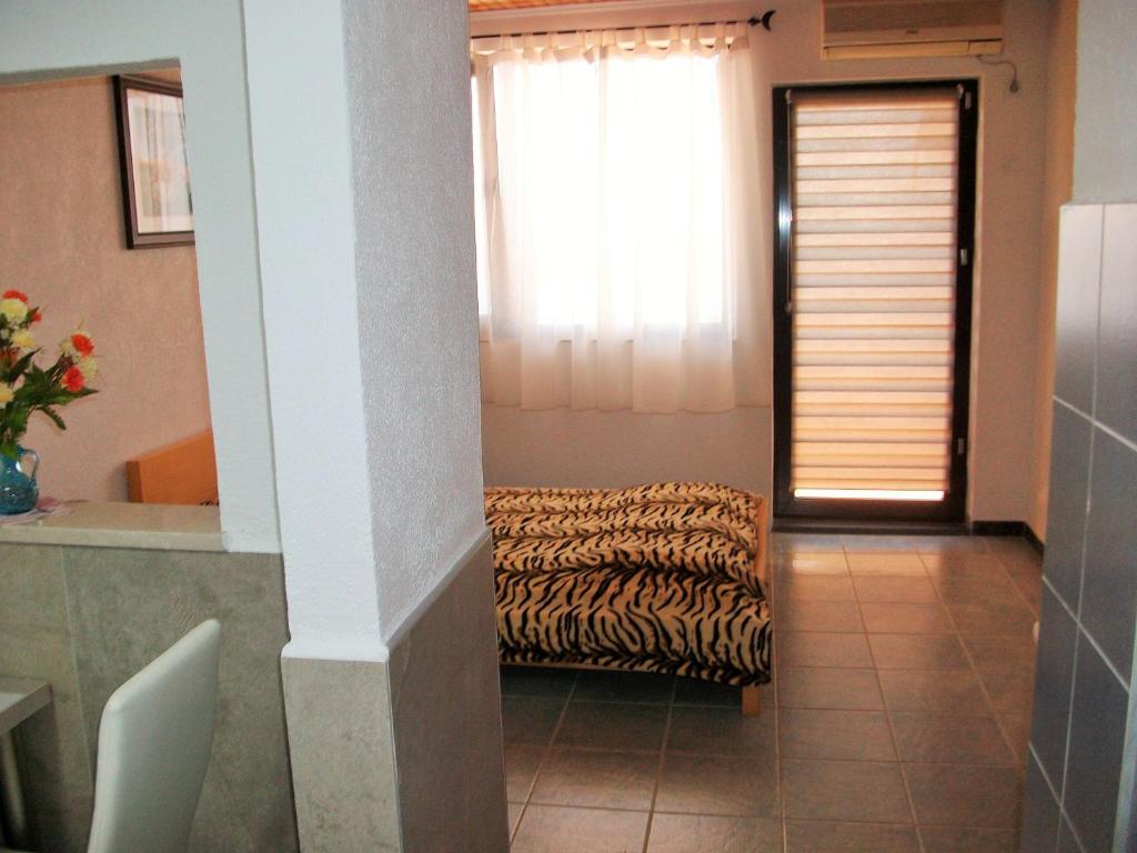 a living room with a couch and a window at Apartments Petrovic in Krimovice