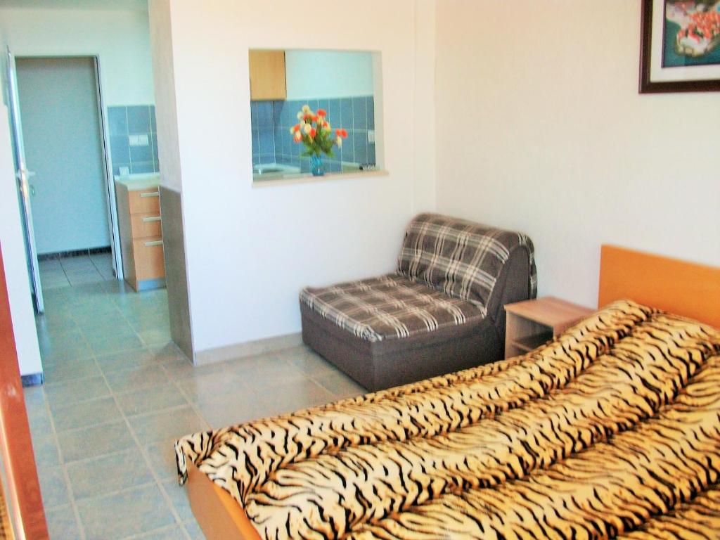 a living room with a couch and a chair at Apartments Petrovic in Krimovice