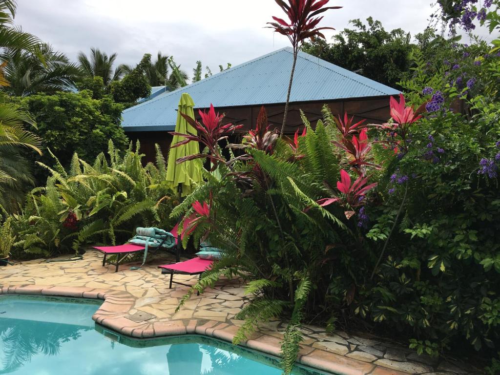 a resort with a swimming pool and a building at Le Chalet dAZAE in La Rivière