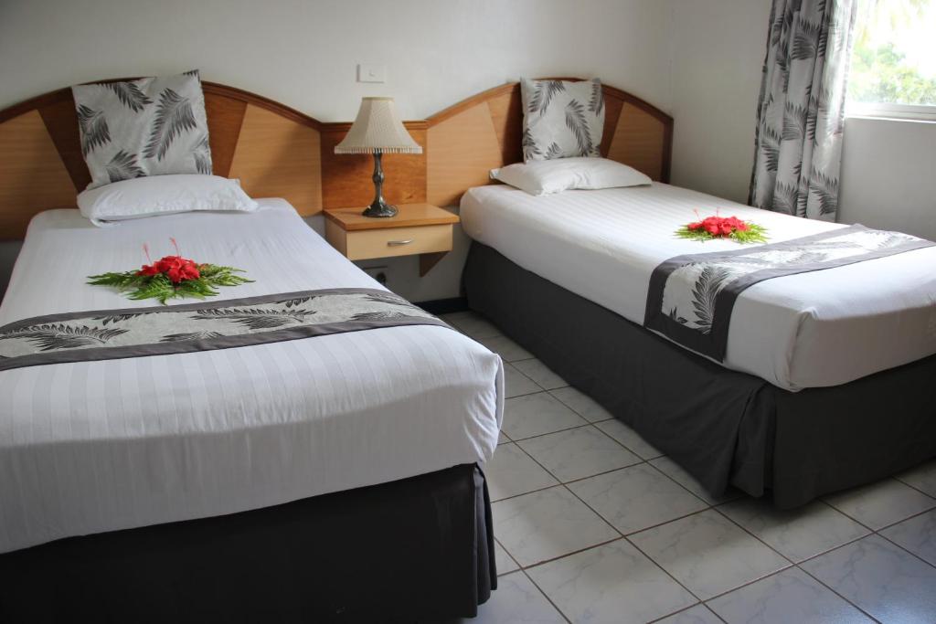 Postel nebo postele na pokoji v ubytování Capricorn International Hotel