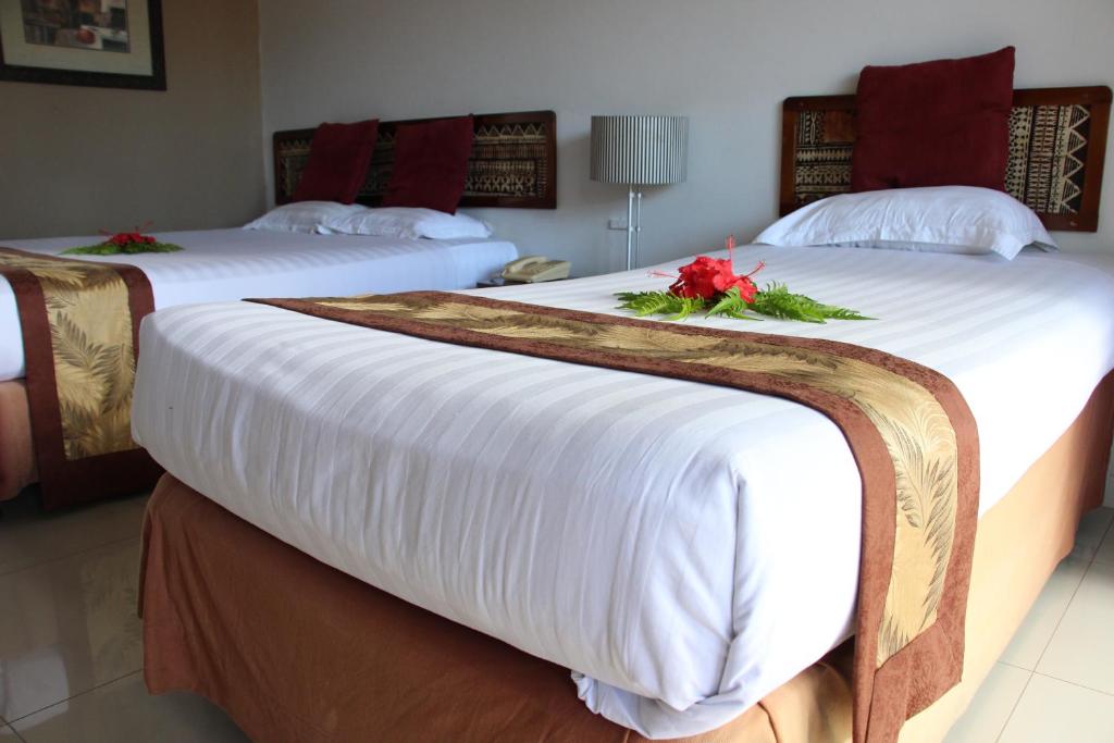 Postel nebo postele na pokoji v ubytování Capricorn International Hotel
