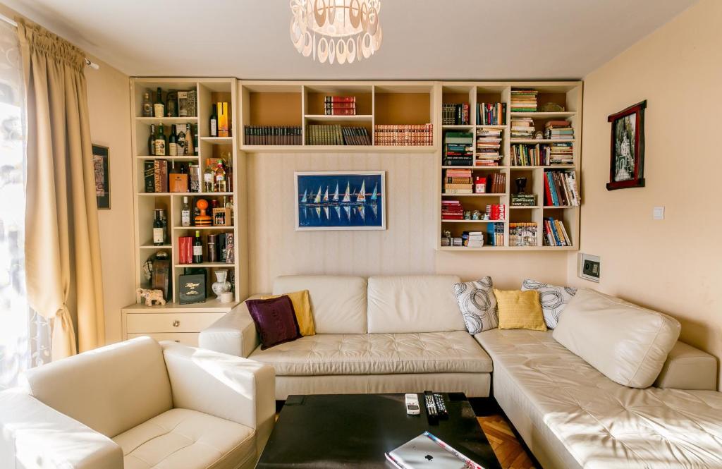 a living room with a couch and bookshelves at Nina in Herceg-Novi
