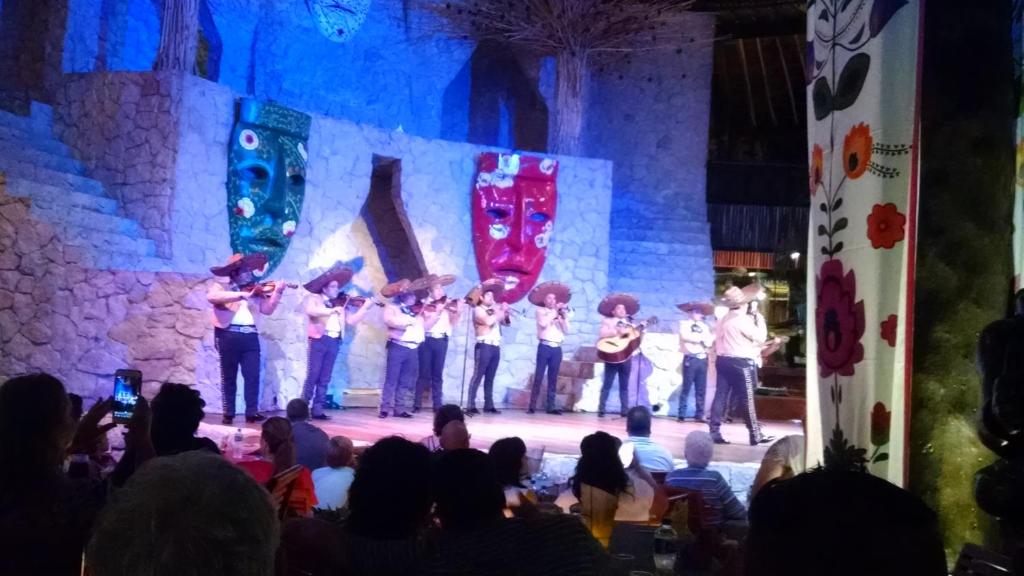 a group of musicians on a stage with a crowd at Suites at Mayan Palace Vidanta Resort Riviera Maya in Playa del Carmen
