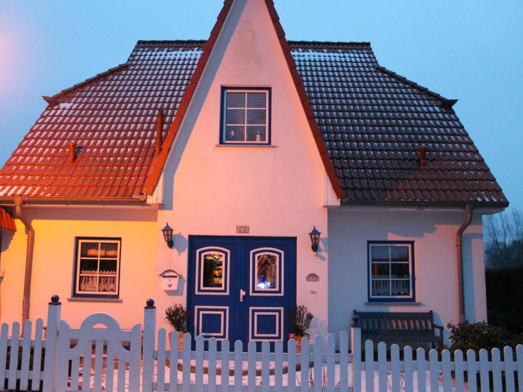 a colorful house with a white fence at Cozy Apartment in Boltenhagen near Seabeach in Boltenhagen