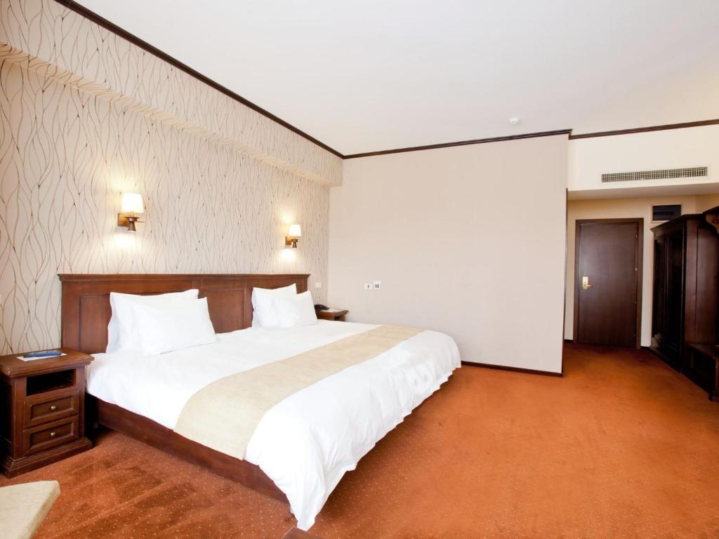 A bed or beds in a room at International Bucharest City Centre Hotel