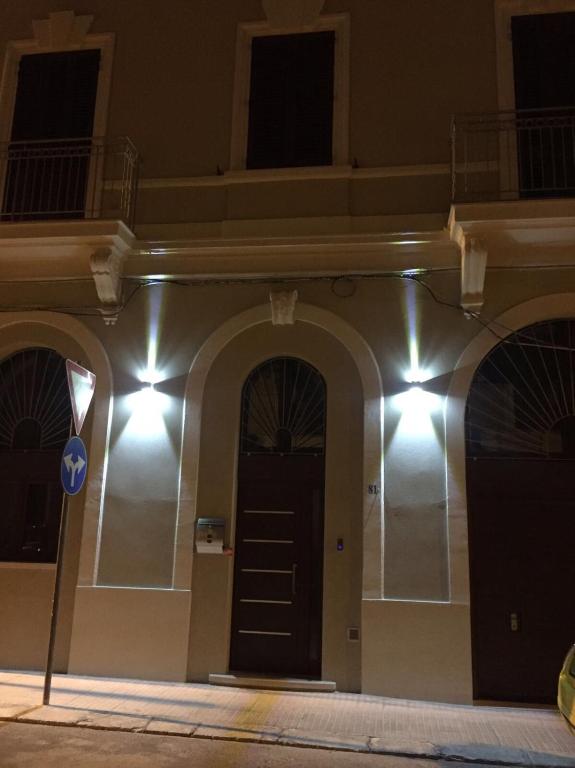 a building with a black door with lights on it at L'arco di porta Lecce in Brindisi