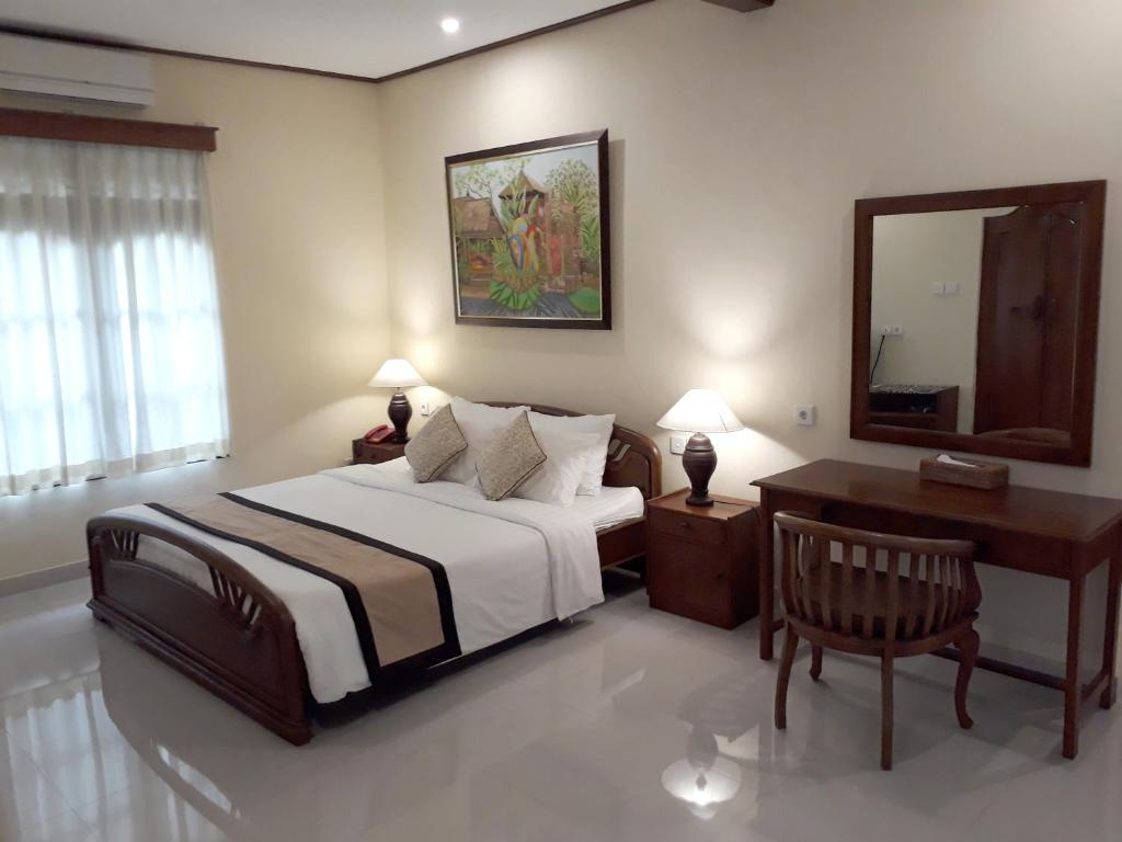 Postel nebo postele na pokoji v ubytování Nyoman Sandi Guest House