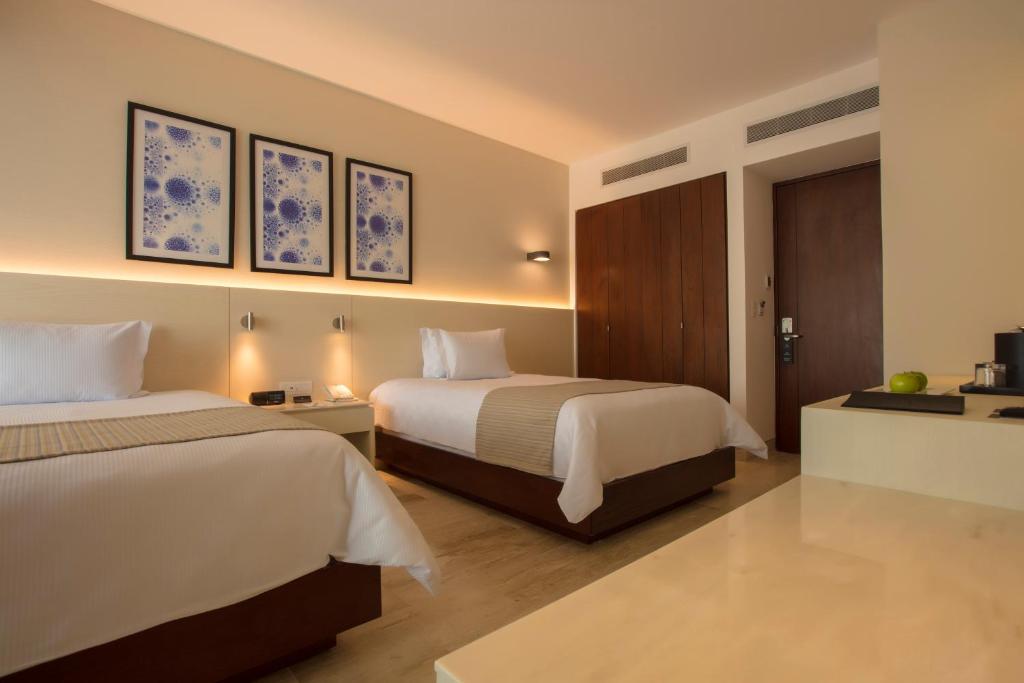 Postel nebo postele na pokoji v ubytování Krystal Grand Cancun All Inclusive