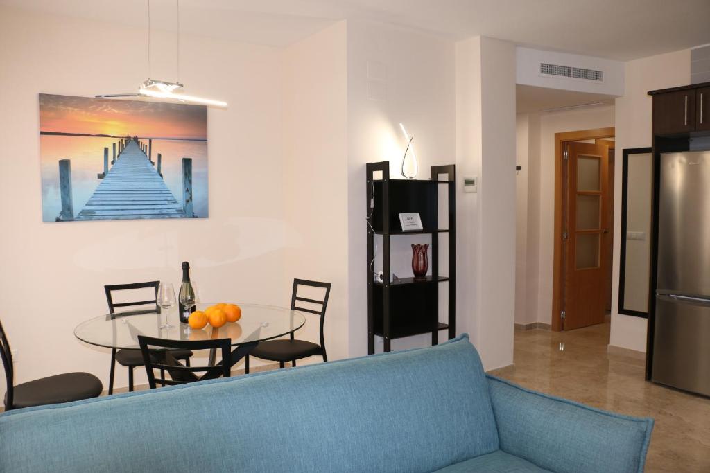 a living room with a blue couch and a table at Apartments Abate 4 in Valencia